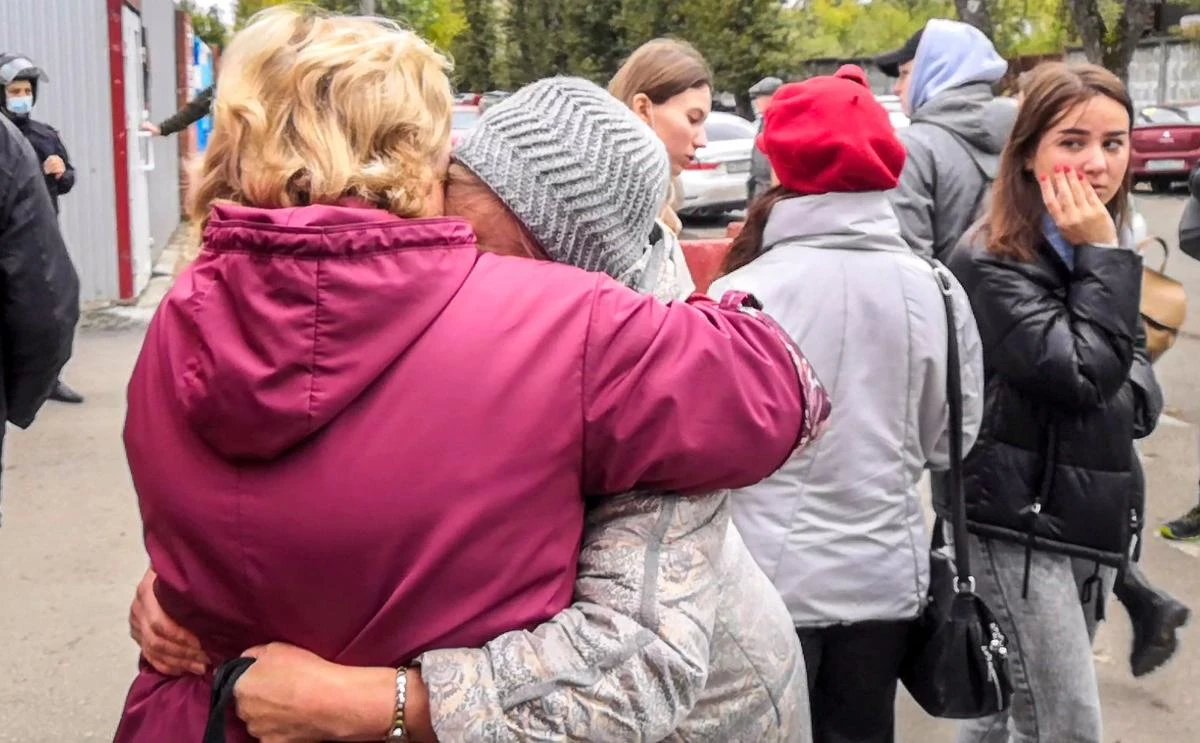 Women react as students evacuate a building of the Perm university campus in Perm on Monday following a shooting. A student opened fire on campus killing at least 8 people in the 2nd mass shooting at an education facility this year. (AFP)