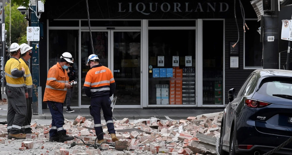Rescue workers examine a damaged building in the popular shopping Chapel Street in Melbourne on September 22, 2021, after a 5.8-magnitude earthquake. (AFP)