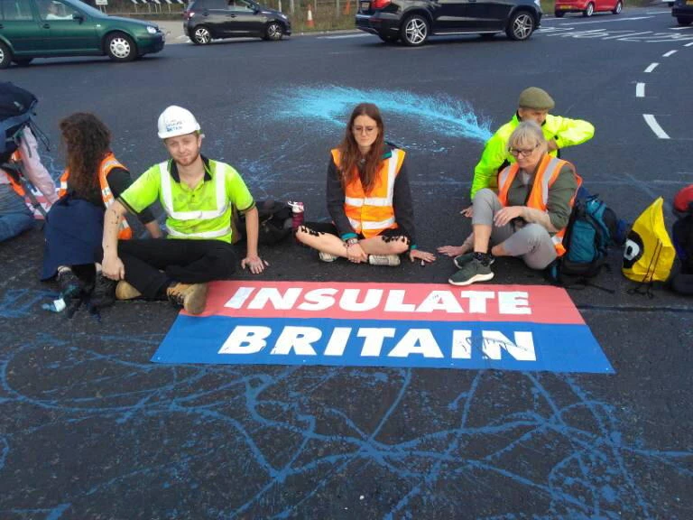 Members of Insulate Britain, demanding that the British government helps provide insulation for 29 million homes, block part of the M25 motorway near London, Britain on Monday. (Reuters)