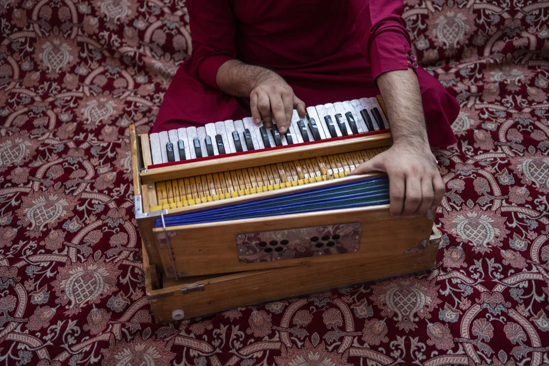 An Afghan musician plays the harmonium during a portrait in Kabul, Afghanistan, Thursday, Sept. 16, 2021. (AP)