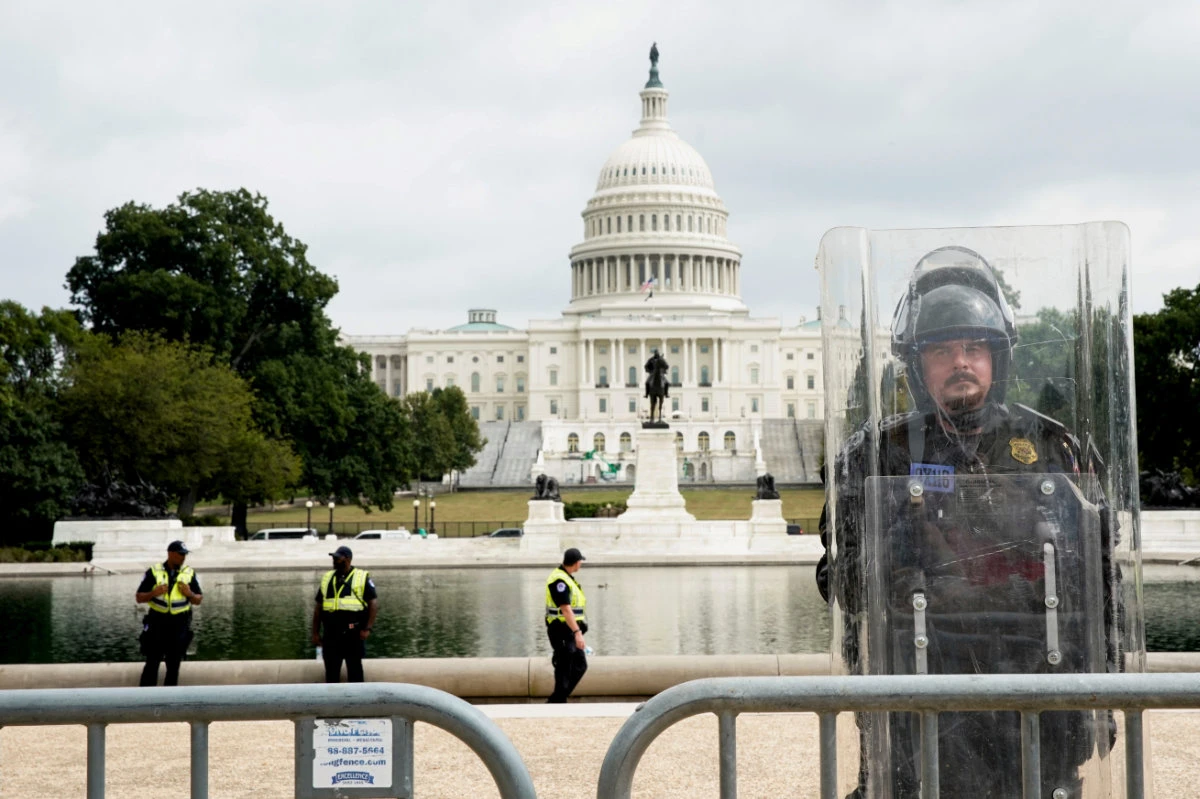 US National Guardsmen stand duty behind the unscalable fence newly topped with razor wire surrounding the US Capitol in Washington D.C. in the wake of the January 6th riot. (REUTERS/File Photo)