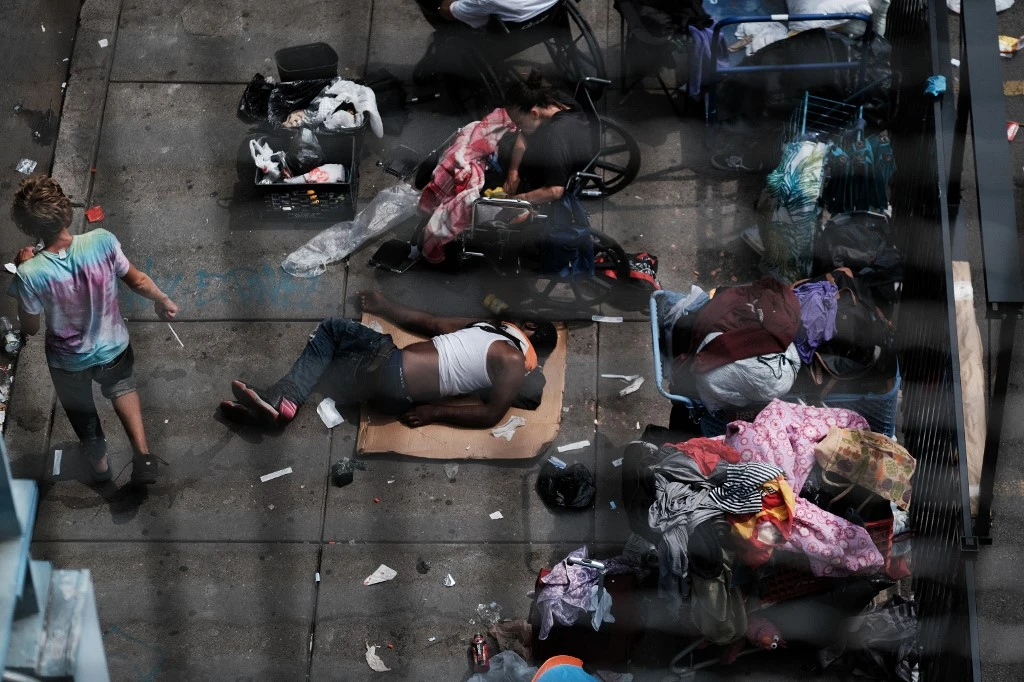 People gather on a street overtaken by heroin users in Kensington on July 19, 2021 in Philadelphia, Pennsylvania. (File/AFP)