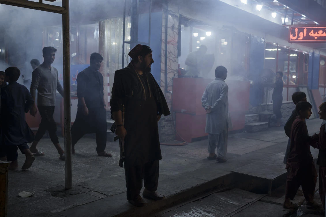 An armed Taliban fighter stands in the corner of a busy street at night in Kabul, Afghanistan, Friday, Sept. 17, 2021. (AP)