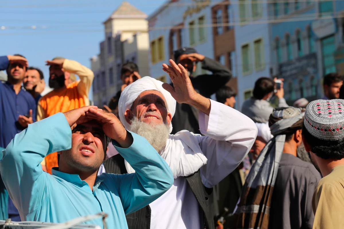 People look up at a dead body hanged by the Taliban from a crane in the main square of Herat city in western Afghanistan, on Saturday Sept. 29, 2021. (AP)