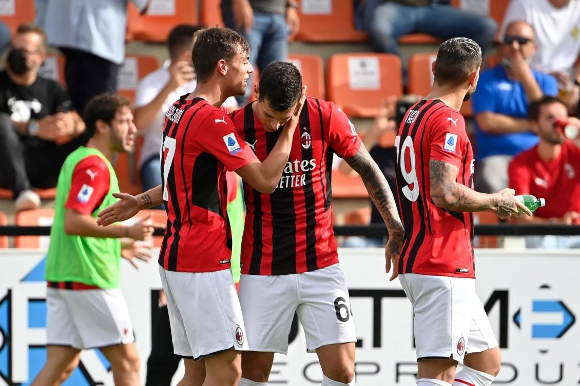 AC Milan’s Italian forward Pietro Pellegri congratulates teammate forward Daniel Maldini after Maldini opened the scoring during the Italian Serie A football match between Spezia and AC Milan on Saturday at the Alberto-Picco stadium in La Spezia. (AFP)