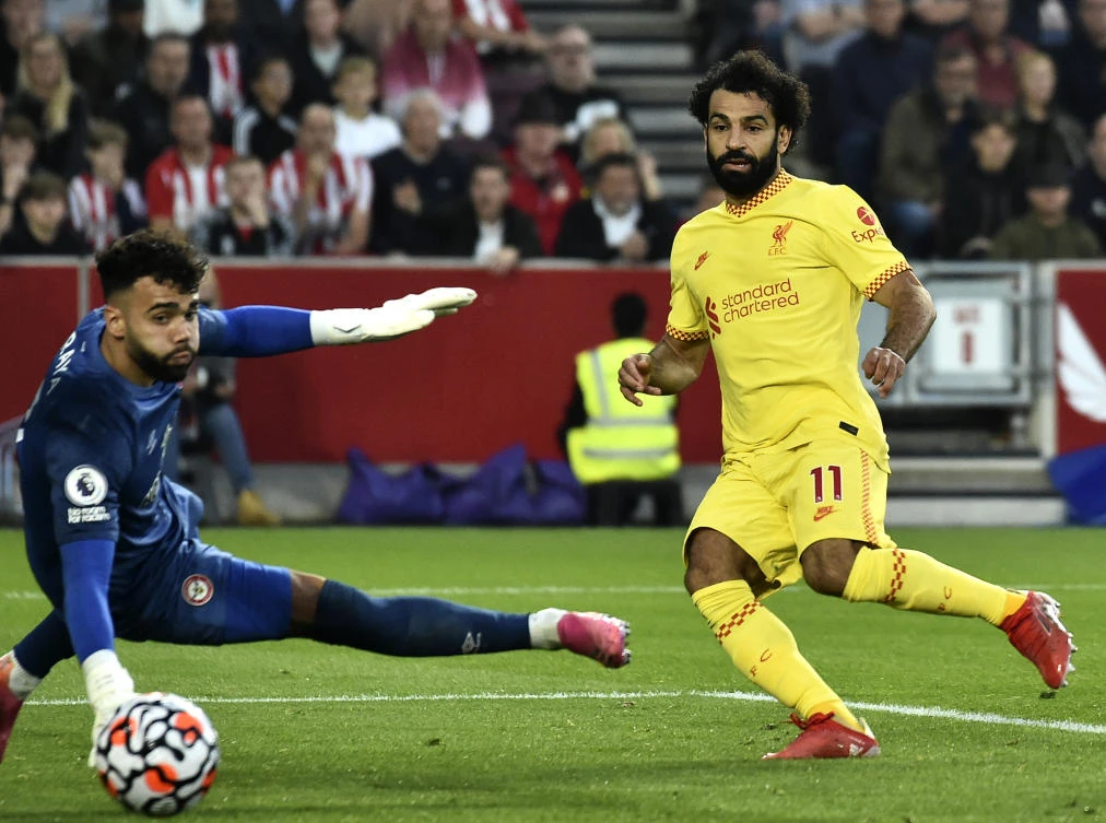 Liverpool’s Mohamed Salah scores his side’s second goal during the English Premier League match against Brentford at the Brentford Community Stadium in London on Saturday. (AP)