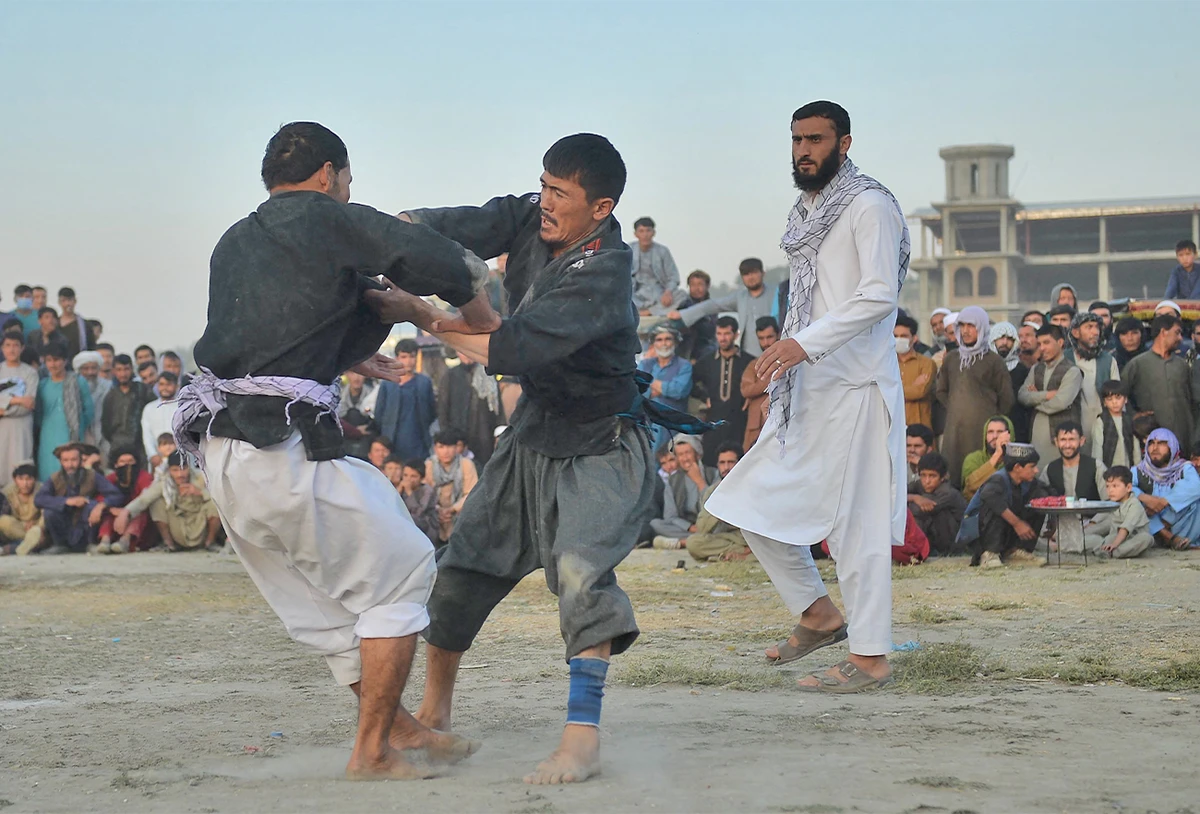 This picture taken on September 24, 2021 shows a fighter celebrating after compiting in a judo and wrestling gathering in Chaman-e-Huzuri park, downtown Kabul, Afghanistan. (AFP)