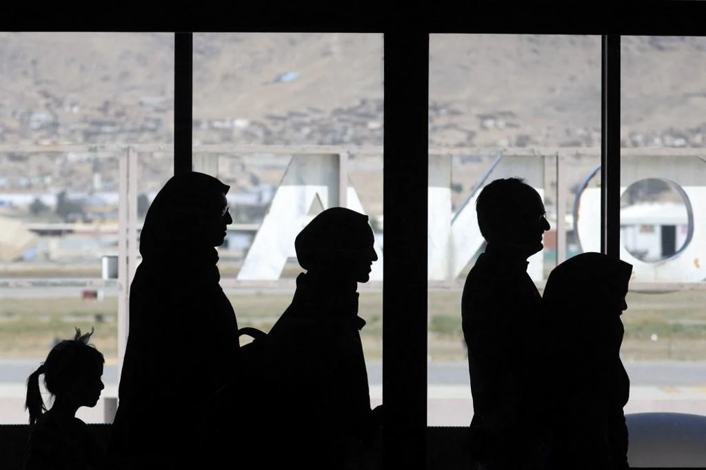 Passengers prepare to board a Pakistan International Airlines aircraft, the first international commercial flight to land at Kabul airport since the Taliban retook power in Afghanistan, on Sept. 13, 2021. (AFP)