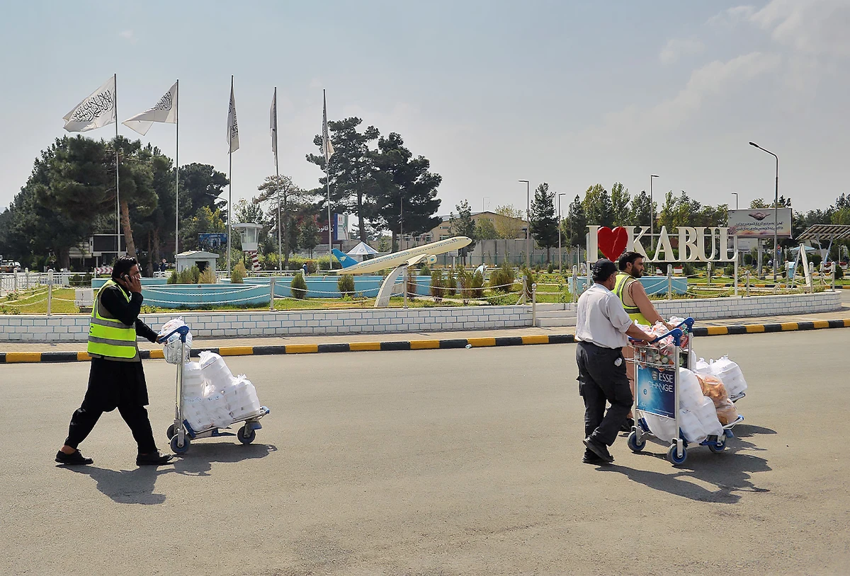 Airport staff carry catering on trolleys outside the airport in Kabul, Afghanistan, on September 22, 2021. (AFP/File)