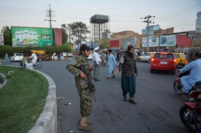 Taliban fighters stand guard along a road in Herat on September. (File/AFP)