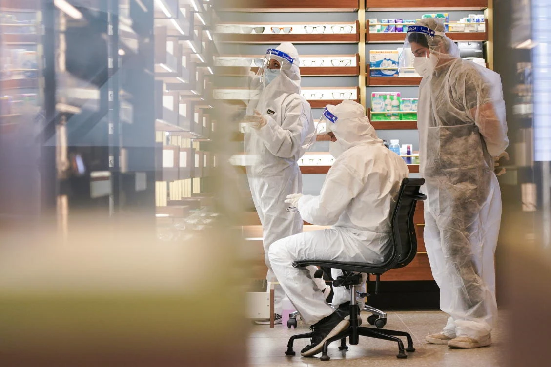 A cleaning crew wearing personal protective equipment work inside a closed shop in Sydney, Australia on Sept. 24, 2021. (Reuters)