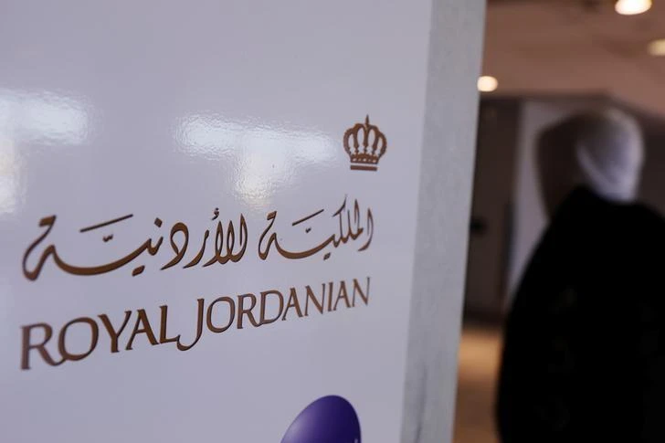 A traveler walks past a sign for Royal Jordanian airline at JFK International Airport in New York, U.S., March 21, 2017. (Reuters)