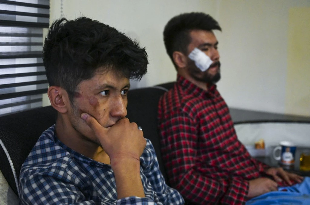 Above, Afghan newspaper Etilaat Roz journalists Nematullah Naqdi, right, and Taqi Daryabi sit in their office after being released from Taliban custody in Kabul on Sept. 8, 2021. (AFP)