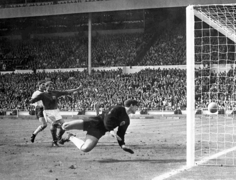 In this July 30, 1966 file photo, England’s Roger Hunt raises his arms as Geoff Hurst scores England’s third goal past German goalkeeper Hans Tilkowski during the World Cup Final at Wembley Stadium. (AP)