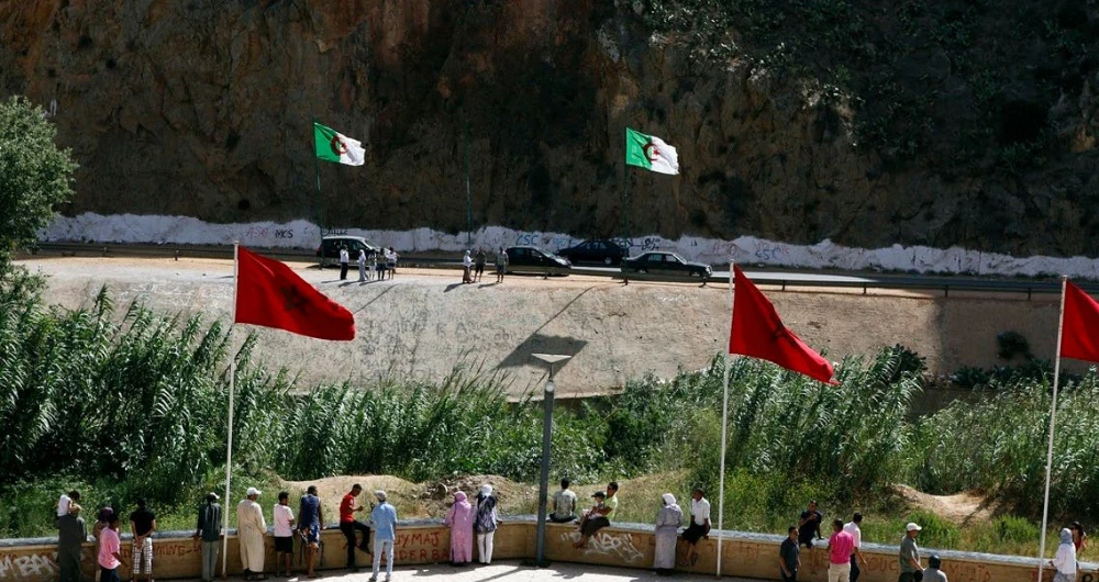 People stand near a border post on the Algerian side of the Morocco-Algeria border in the north east of Morocco. (Reuters/File)