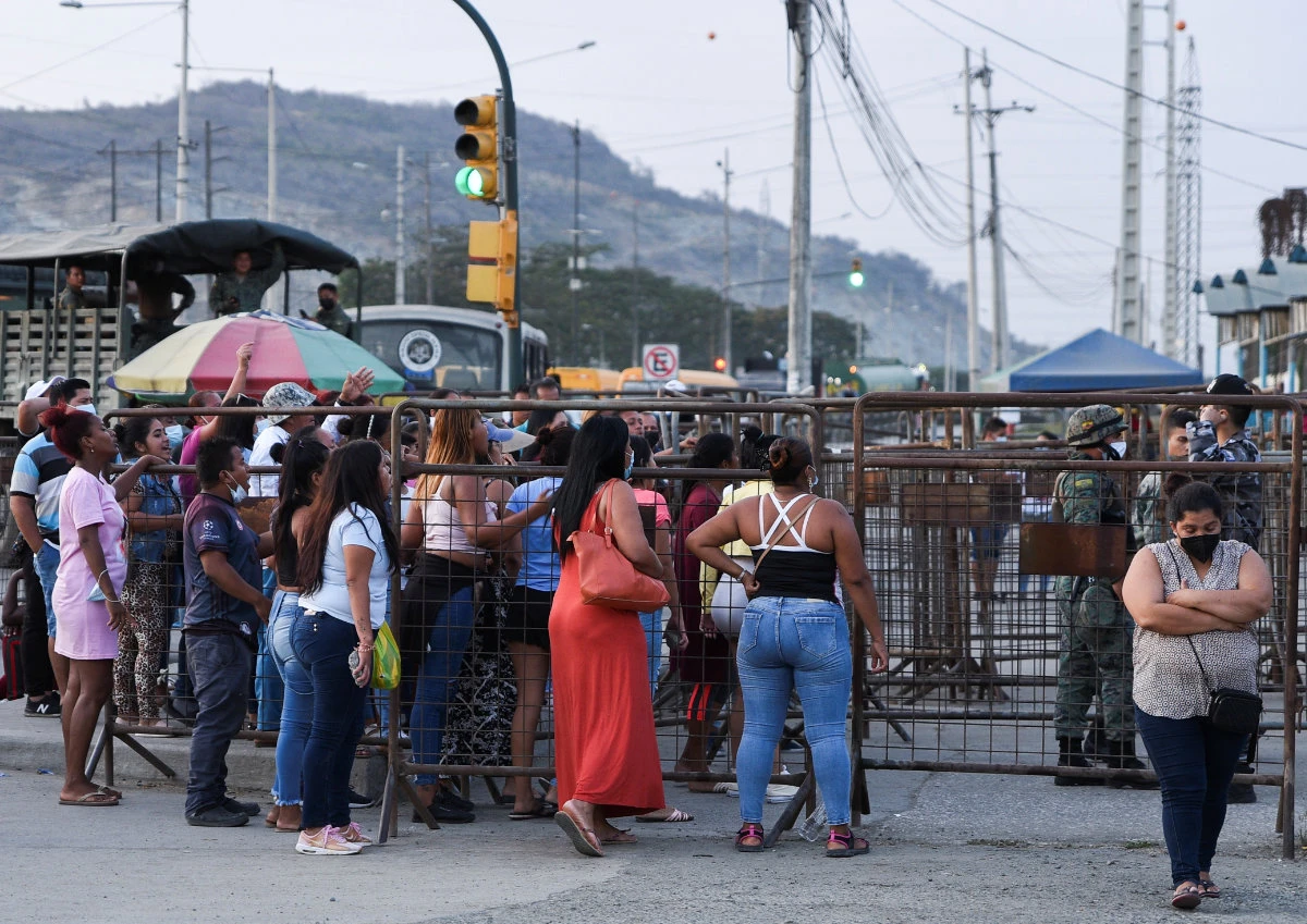 Family members of inmates wait at the Penitenciaria del Litoral jail after prisoners died and others were injured in a riot in Guayaquil, Ecuador, on Sept. 28, 2021. (REUTERS)