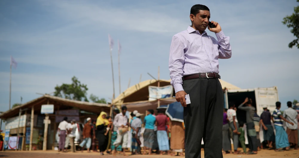 Mohibullah, a leader of Arakan Rohingya Society for Peace and Human Rights, talks on the phone in Kutupalong camp in Cox's Bazar, Bangladesh. (Reuters/File)