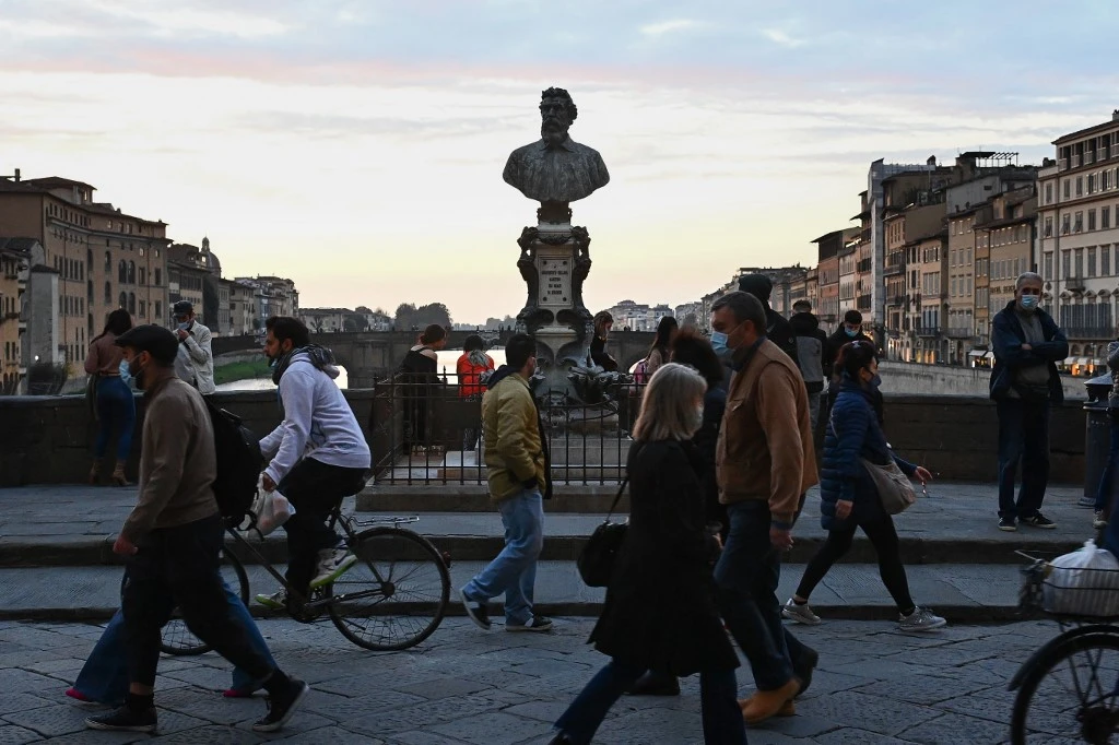 Most of the Afghan students enrolled at University of Florence are studying history, archaeology, geography and art. Above, people walk across the Ponte Vecchio above the Arno river in Florence. (AFP)