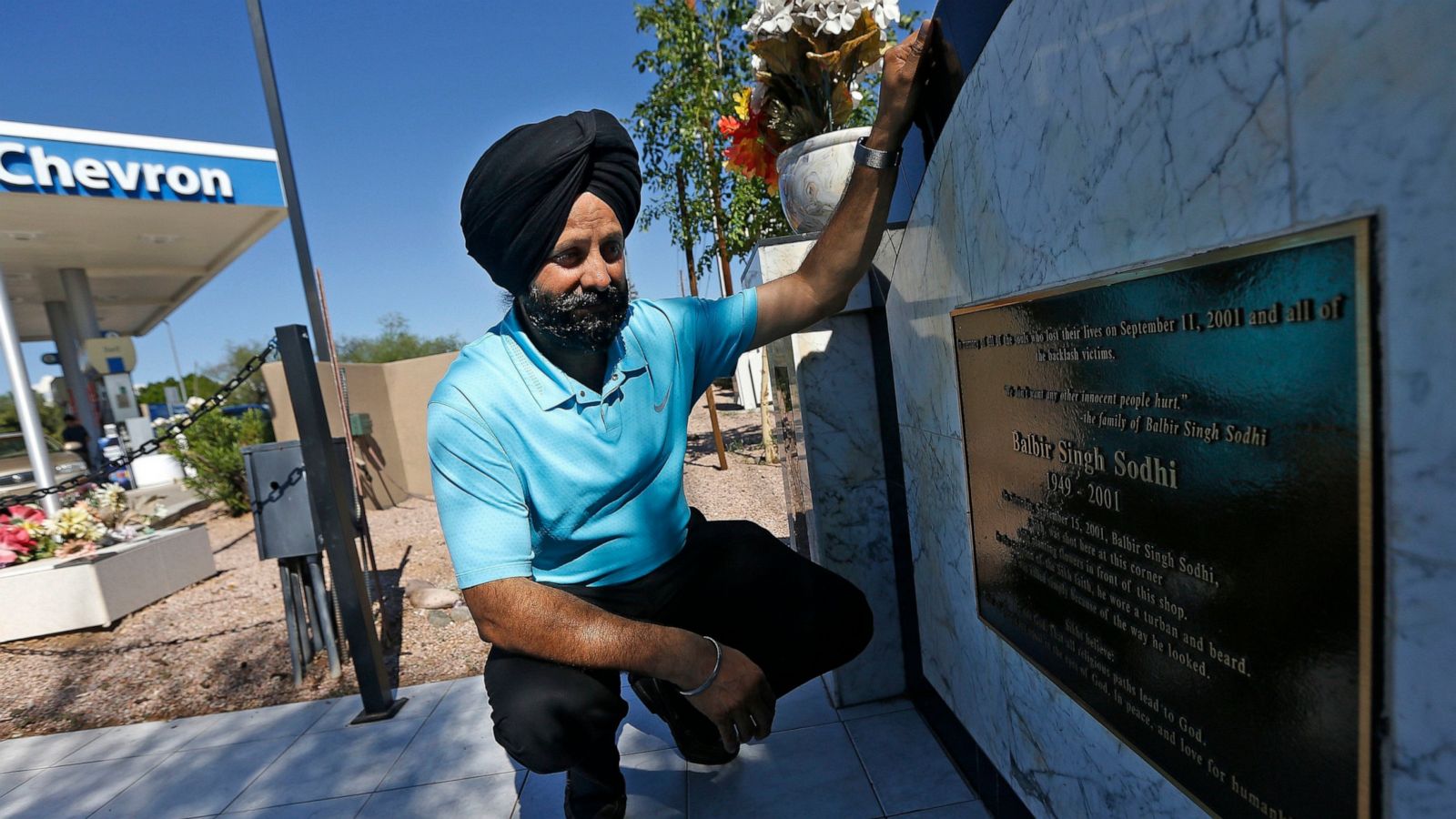 Rana Singh Sodhi kneels next to a memorial in Mesa, Ariz., for his brother, Balbir Singh Sodhi, who was gunned down after the 9/11 attacks. (AP Photo)
