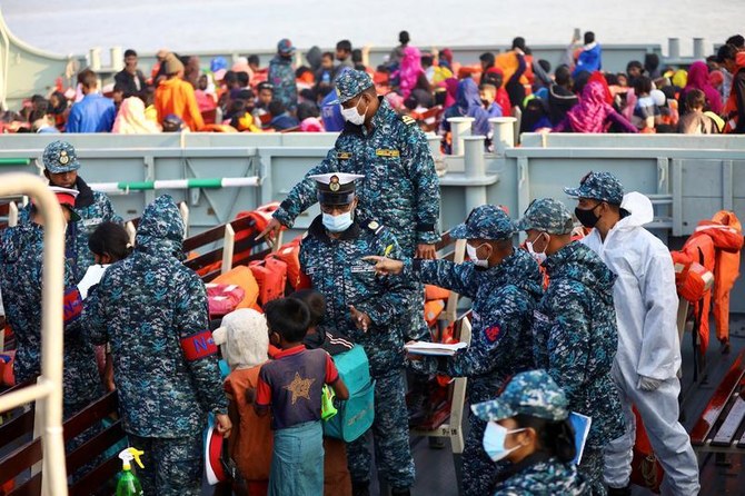 Bangladesh navy personnel check Rohingya refugees before their relocation to Bhasan Char island, Chattogram, Bangladesh, Dec. 29, 2020. (Reuters)