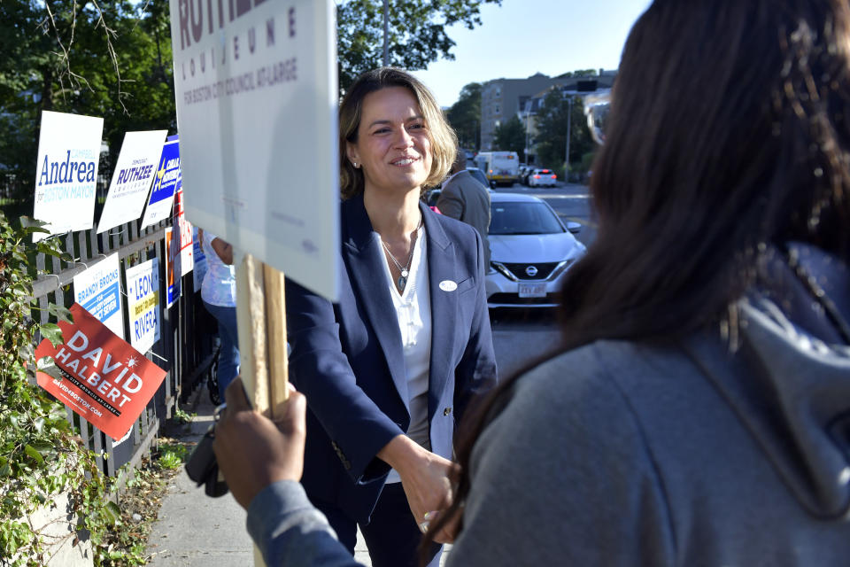 Mayoral candidate Annissa Essaibi George greets campaigners outside a polling station in Roxbury, Boston, Sept. 14, 2021. (AP Photo)