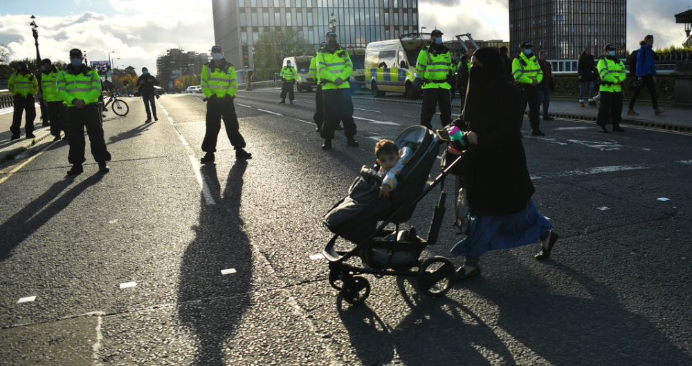 Police officers stand guard as climate activists take part in a demonstration ahead of the COP26 summit, in Glasgow, Scotland, Britain, October 30, 2021. (Reuters)