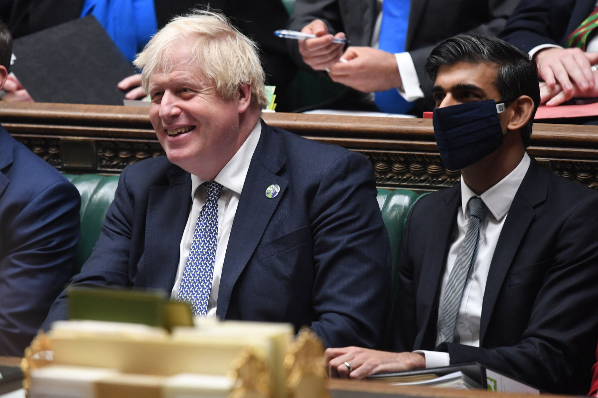 Britain’s PM Boris Johnson (L) and Chancellor of the Exchequer Rishi Sunak attending the Prime Minister’s Questions at the House of Commons in London on Oct. 27, 2021. (AFP/Handout photo)