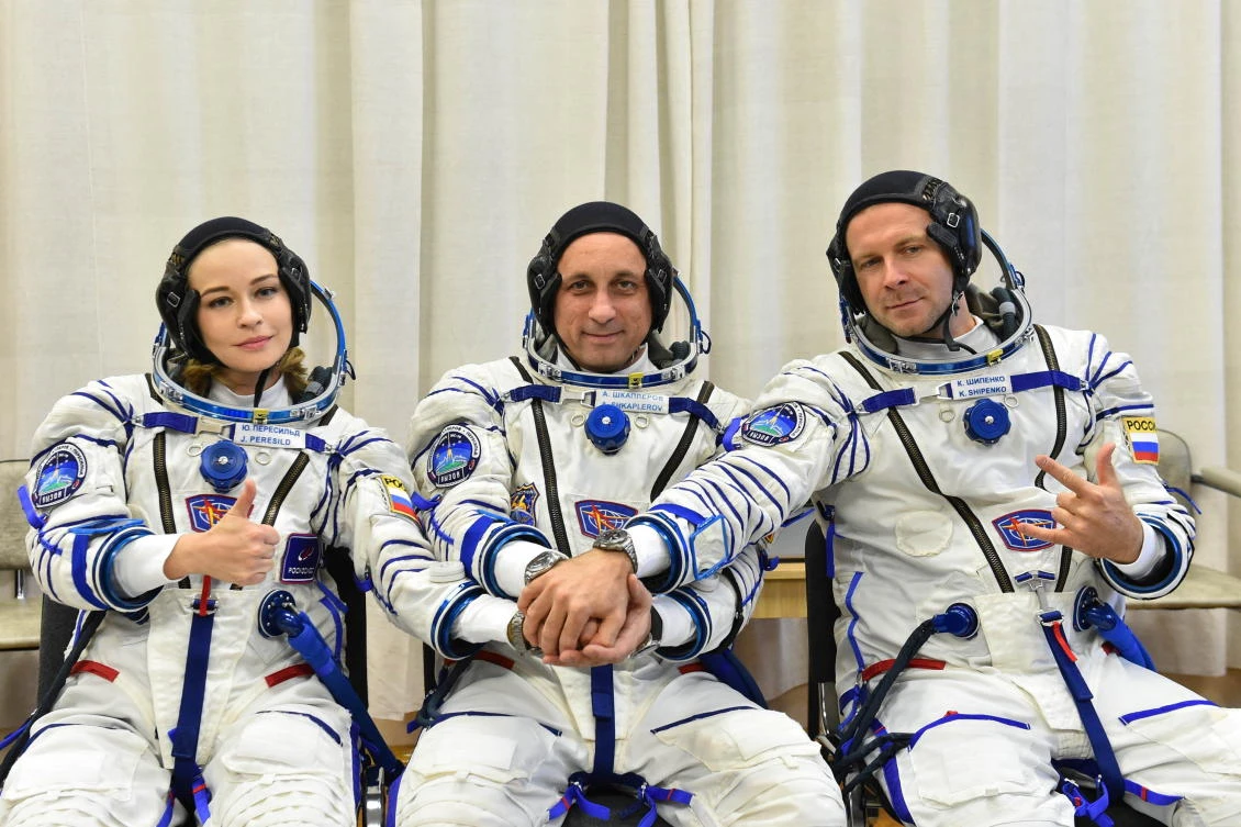 The International Space Station (ISS) crew members Russian cosmonaut Anton Shkaplerov, film director Klim Shipenko and actor Yulia Peresild pose after donning space suits shortly before the launch at the Baikonur Cosmodrome, Kazakhstan October 5, 2021. Andrey Shelepin/GCTC/Roscosmos/Handout via REUTERS ATTENTION EDITORS - THIS IMAGE HAS BEEN SUPPLIED BY A THIRD PARTY. MANDATORY CREDIT.