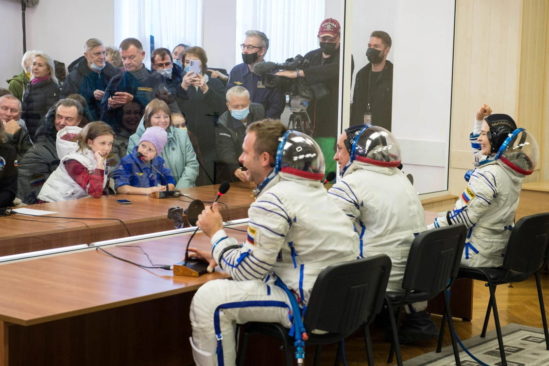 The International Space Station (ISS) crew members Russian cosmonaut Anton Shkaplerov, film director Klim Shipenko and actor Yulia Peresild talk with relatives and friends after donning space suits shortly before the launch at the Baikonur Cosmodrome, Kazakhstan October 5, 2021. Andrey Shelepin/GCTC/Roscosmos/Handout via REUTERS ATTENTION EDITORS - THIS IMAGE HAS BEEN SUPPLIED BY A THIRD PARTY. MANDATORY CREDIT.