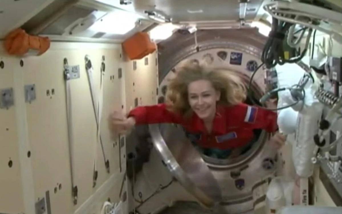 The International Space Station (ISS) crew member Russian actor Yulia Peresild enters the ISS after docking on October 5, 2021 in this still image taken from video. Roscosmos/Handout via REUTERS ATTENTION EDITORS - THIS IMAGE HAS BEEN SUPPLIED BY A THIRD PARTY. MANDATORY CREDIT.