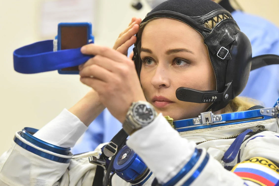 The International Space Station (ISS) crew member Russian actor Yulia Peresild looks at a mirror after donning space suit shortly before the launch at the Baikonur Cosmodrome, Kazakhstan October 5, 2021. Andrey Shelepin/GCTC/Roscosmos/Handout via REUTERS ATTENTION EDITORS - THIS IMAGE HAS BEEN SUPPLIED BY A THIRD PARTY. MANDATORY CREDIT.