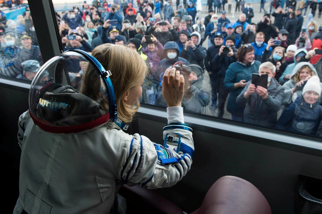 The International Space Station (ISS) crew member Russian actor Yulia Peresild waves from a bus as she departs for boarding the Soyuz MS-19 spacecraft for the launch at the Baikonur Cosmodrome, Kazakhstan October 5, 2021. Andrey Shelepin/GCTC/Roscosmos/Handout via REUTERS ATTENTION EDITORS - THIS IMAGE HAS BEEN SUPPLIED BY A THIRD PARTY. MANDATORY CREDIT.
