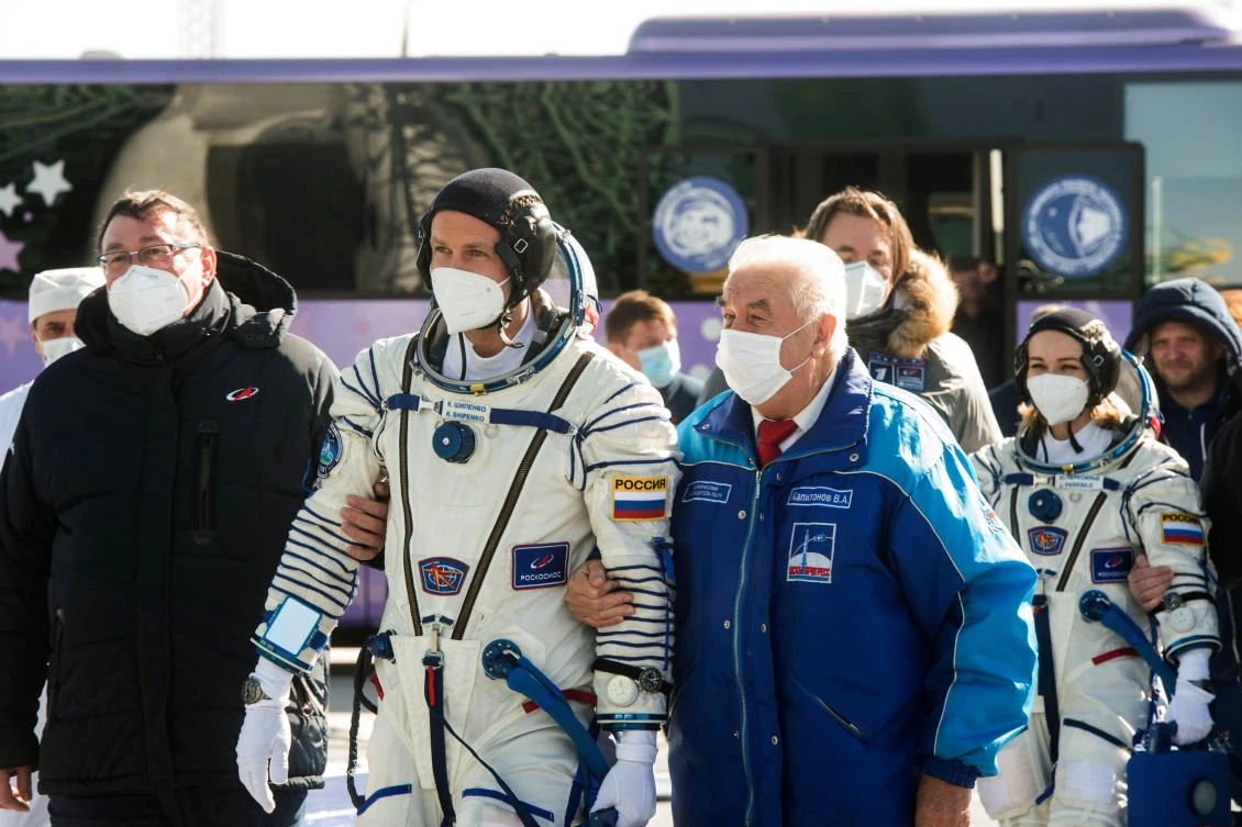 The International Space Station (ISS) crew members Russian film director Klim Shipenko and actor Yulia Peresild walk to board the Soyuz MS-19 spacecraft for the launch at the Baikonur Cosmodrome, Kazakhstan October 5, 2021. Andrey Shelepin/GCTC/Roscosmos/Handout via REUTERS ATTENTION EDITORS - THIS IMAGE HAS BEEN SUPPLIED BY A THIRD PARTY. MANDATORY CREDIT.
