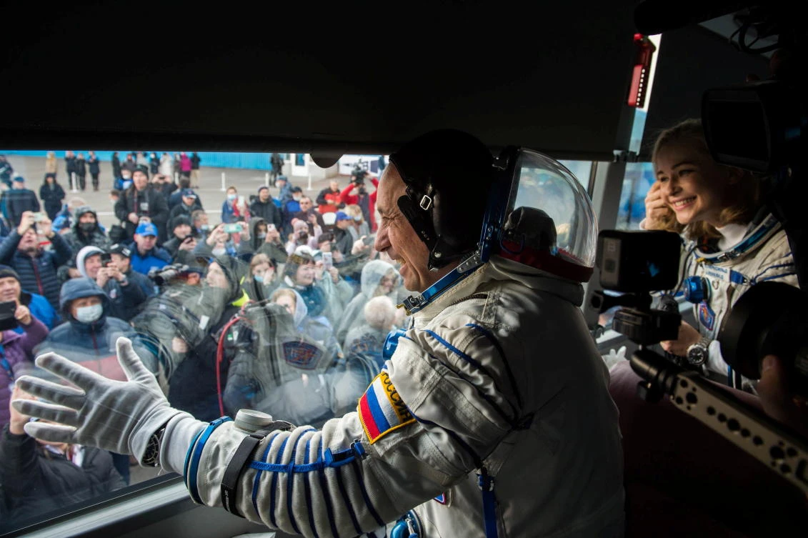 The International Space Station (ISS) crew members Russian cosmonaut Anton Shkaplerov and actor Yulia Peresild wave farewell from a bus as they depart for boarding the Soyuz MS-19 spacecraft for the launch at the Baikonur Cosmodrome, Kazakhstan October 5, 2021. Andrey Shelepin/GCTC/Roscosmos/Handout via REUTERS ATTENTION EDITORS - THIS IMAGE HAS BEEN SUPPLIED BY A THIRD PARTY. MANDATORY CREDIT.