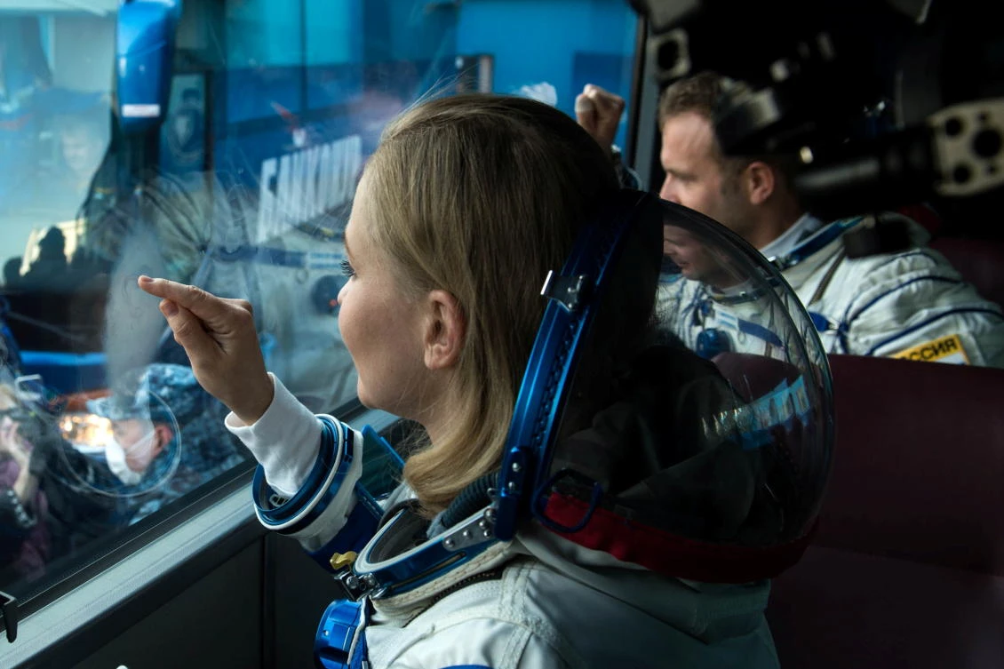 The International Space Station (ISS) crew member Russian actor Yulia Peresild gestures in a bus as she departs for boarding the Soyuz MS-19 spacecraft for the launch at the Baikonur Cosmodrome, Kazakhstan October 5, 2021. Andrey Shelepin/GCTC/Roscosmos/Handout via REUTERS ATTENTION EDITORS - THIS IMAGE HAS BEEN SUPPLIED BY A THIRD PARTY. MANDATORY CREDIT.