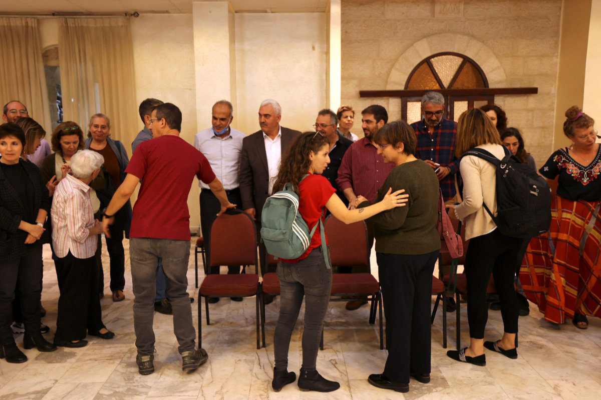 Israeli left wing activists gather with Palestinian activists at the Al-Haq Foundation in Ramallah on Oct. 27, 2021, to denounce Israel’s decision to declare six Palestinian human rights groups as “terror organizations.” (ABBAS MOMANI / AFP)
