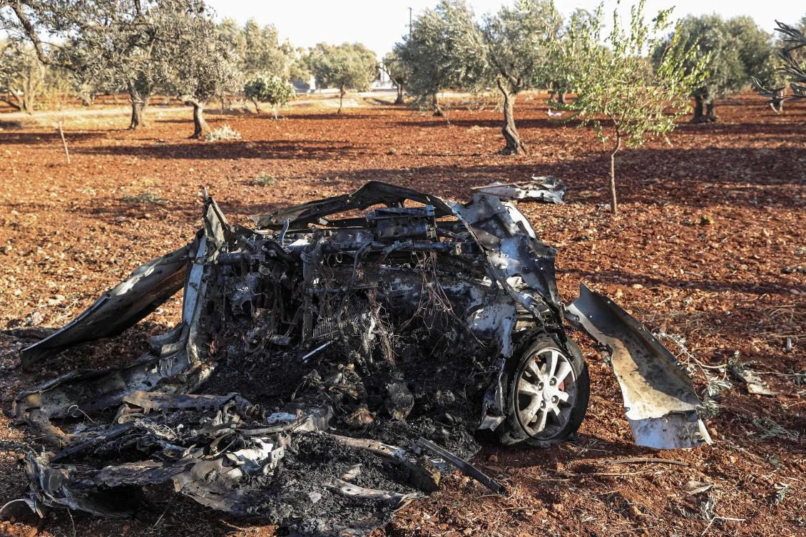 This photo taken on September 20, 2021 shows the remains of a vehicle reportedly destroyed by a drone strike on the northeastern outskirts of Syria's rebel-held city of Idlib. (AFP)