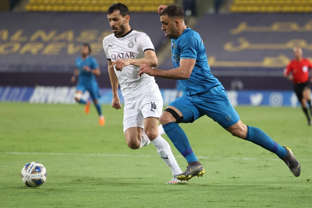 Nassr's forward Abderrazak Hamdallah (R) is marked by Sadd's midfielder Boualem Khoukhi during the AFC Champions League group D match between Qatar's Al-Sadd and Saudi's Al-Nassr on April 29, 2021. (File/AFP)