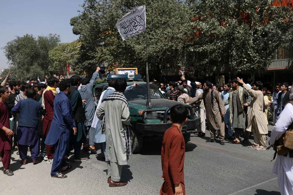 Protesters gather around a car with the Taliban flag raised atop it during the anti-Pakistan protest in Kabul, Afghanistan. (Reuters)