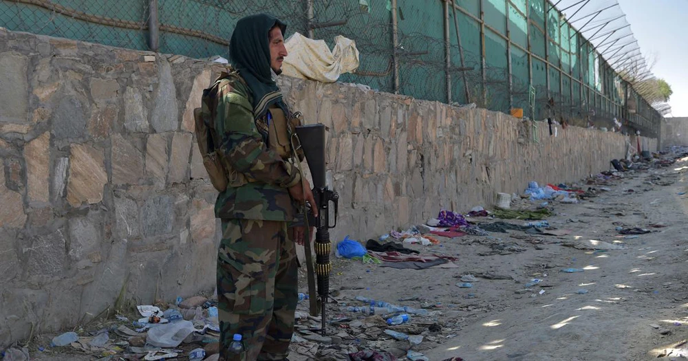 A Taliban fighter stands at the site of the, August 26, suicide bomb attack that killed nearly 200 people. (AFP)