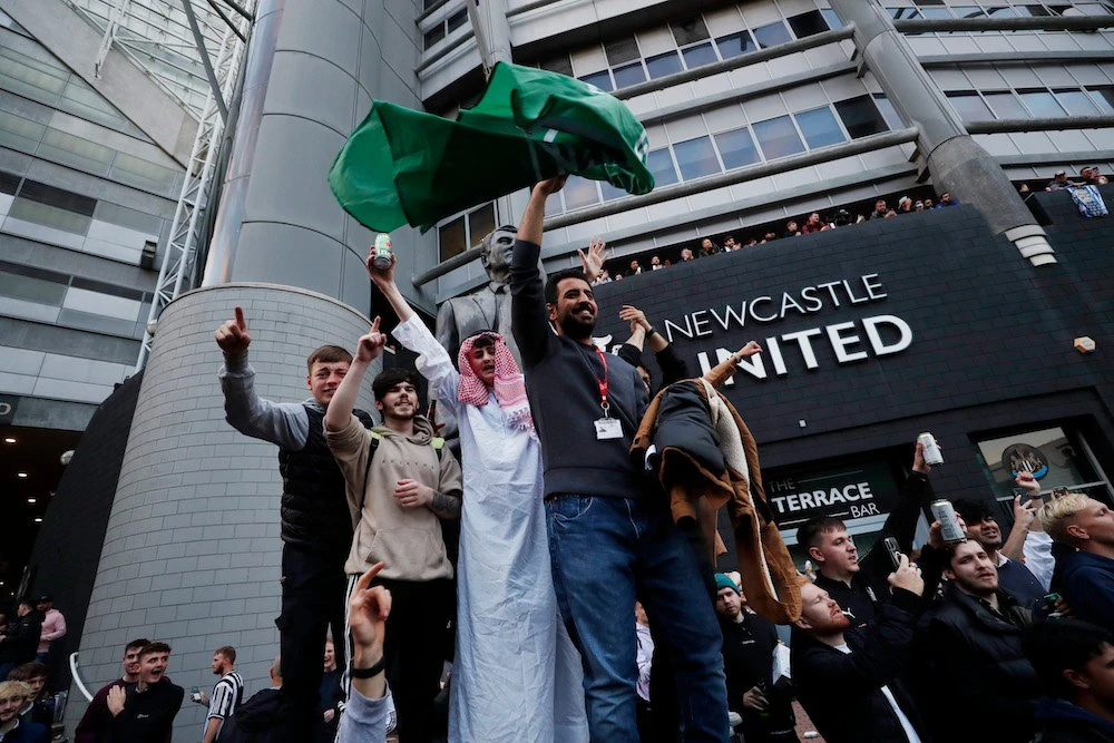 Fans celebrate outside St. James’ Park after the Newcastle United takeover was announced. (Reuters)