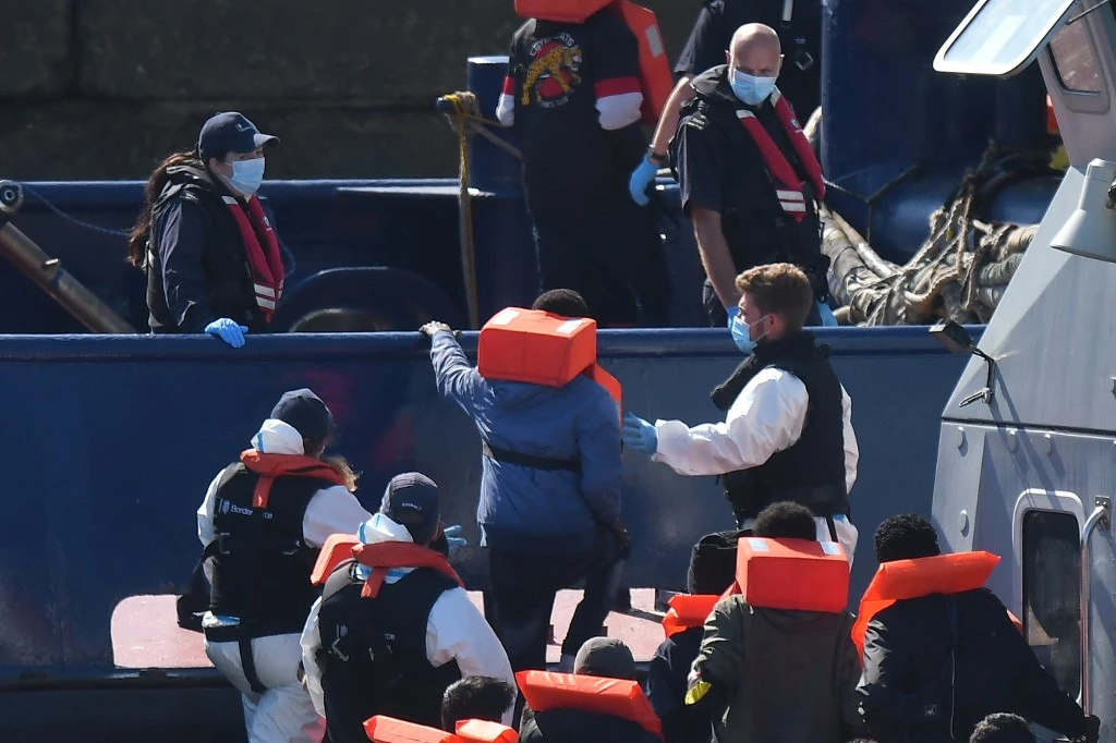 Channel migrants held on double-decker bus as Britain struggles to cope with influx