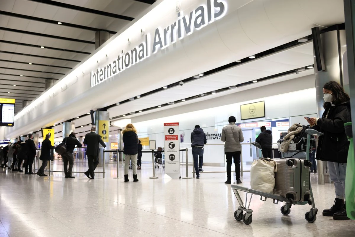 Travelers stand at terminal 2 of Heathrow Airport. (Reuters)