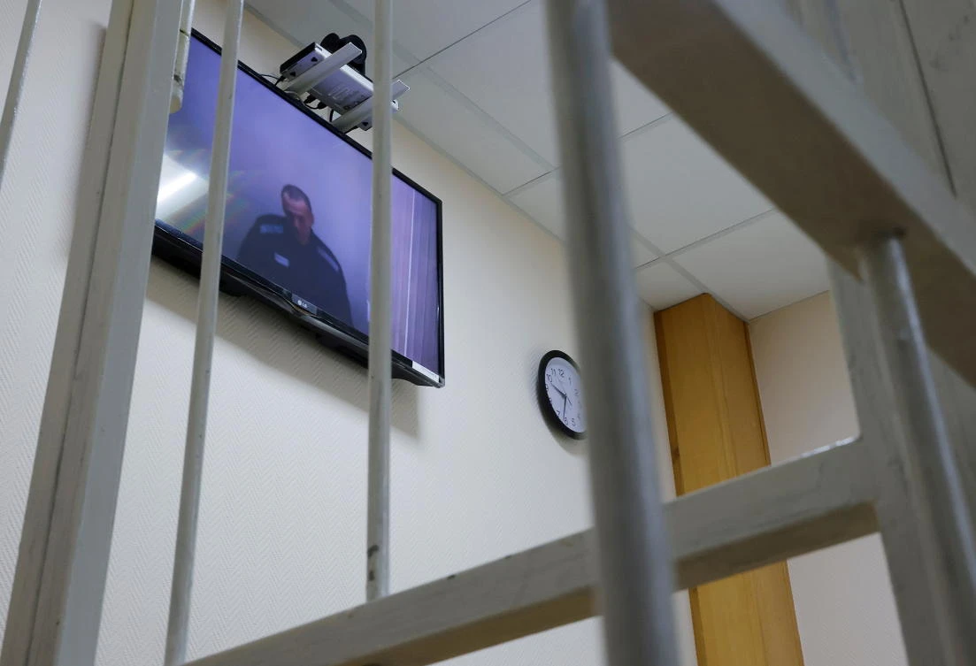 Russian opposition leader Alexei Navalny is seen on a screen via a video link during a hearing to consider his lawsuits against the penal colony over detention conditions there on May 26, 2021. (Reuters)