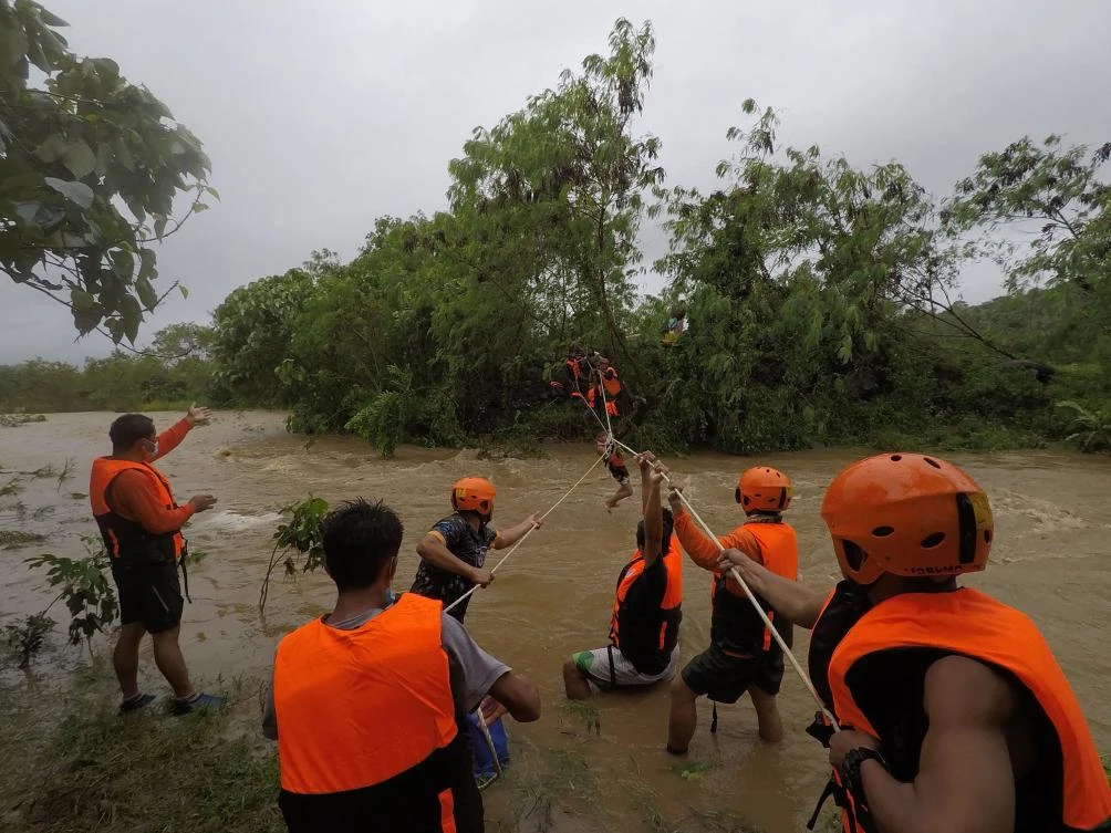 Rescuers evacuate residents from their homes near a swollen river due to heavy rains brought about by Tropical Storm Kompasu in Cagayan province north of Manila. (Gonzaga Municipal Disaster Risk Reduction and Management Office via AFP)