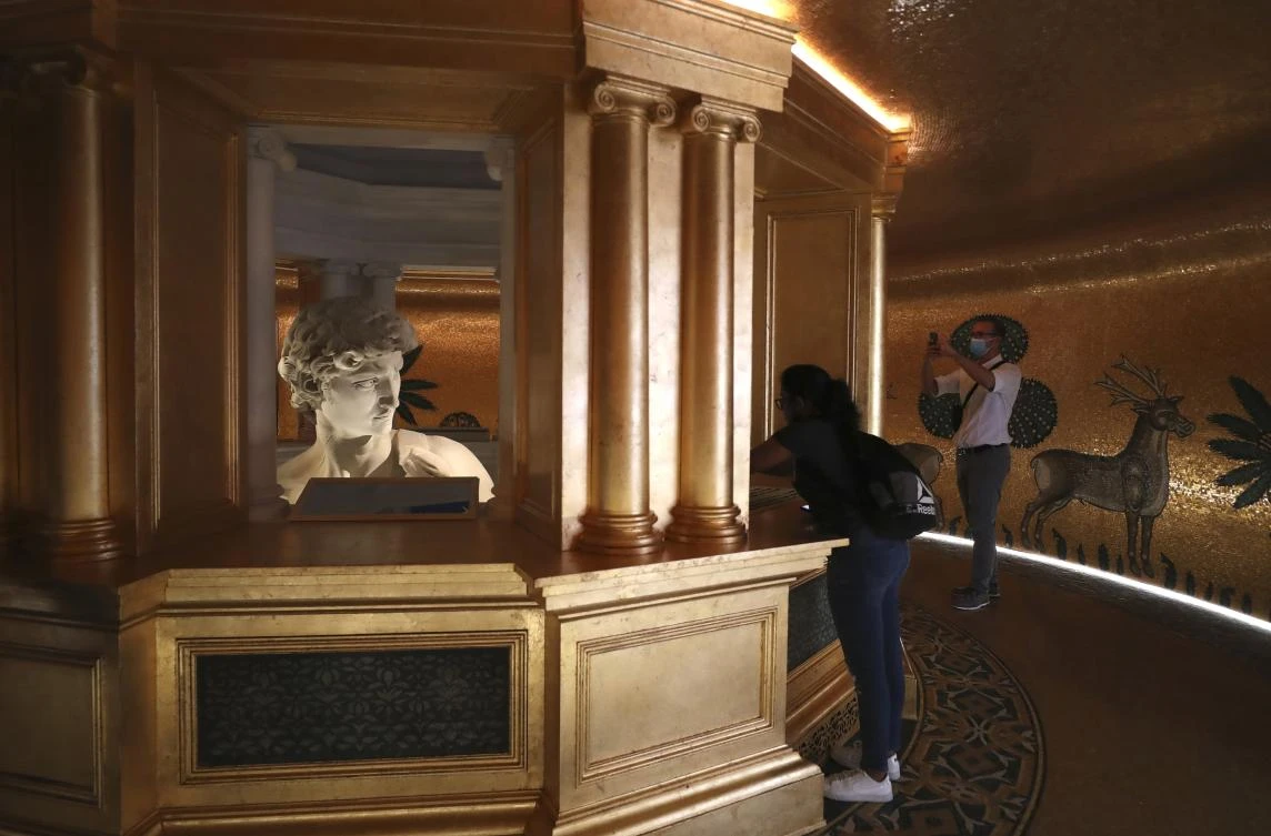 Visitors take photos of the 3D re-production of Michelangelo’s David at the Italy’s pavilion at the Expo 2020 Dubai. (AP)