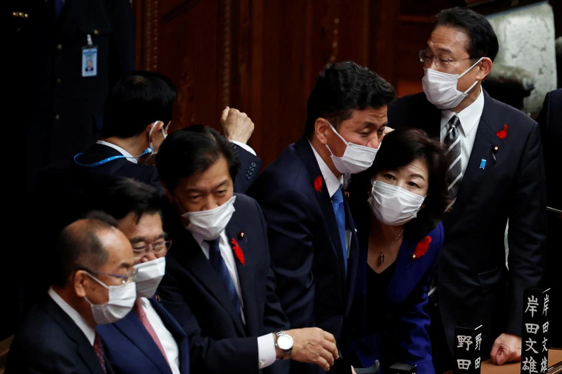 Japan's Prime Minister and the leader of the ruling Liberal Democratic Party (LDP) Fumio Kishida and his ministers interact after the dissolution of the lower house was announced at the Parliament in Tokyo, Japan October 14, 2021. (Reuters)