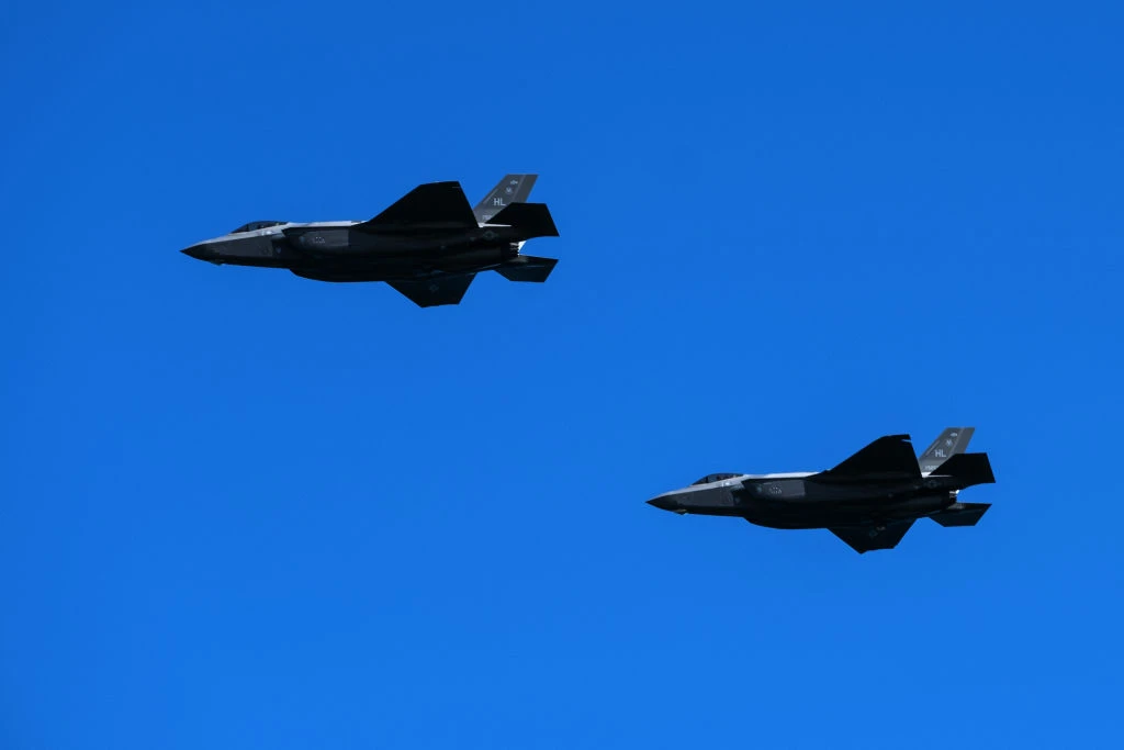 Two US Air Force Lockheed Martin F-35 fighter jets fly over the beach of Houlgate, north-western France (Getty)