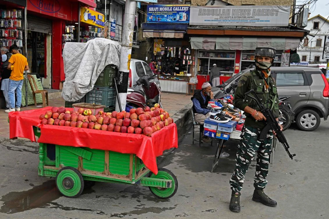 A security personnel stands guard at a market in Srinagar on October 11, 2021, as suspected militants shot dead five soldiers in Indian-administered Kashmir. (AFP)