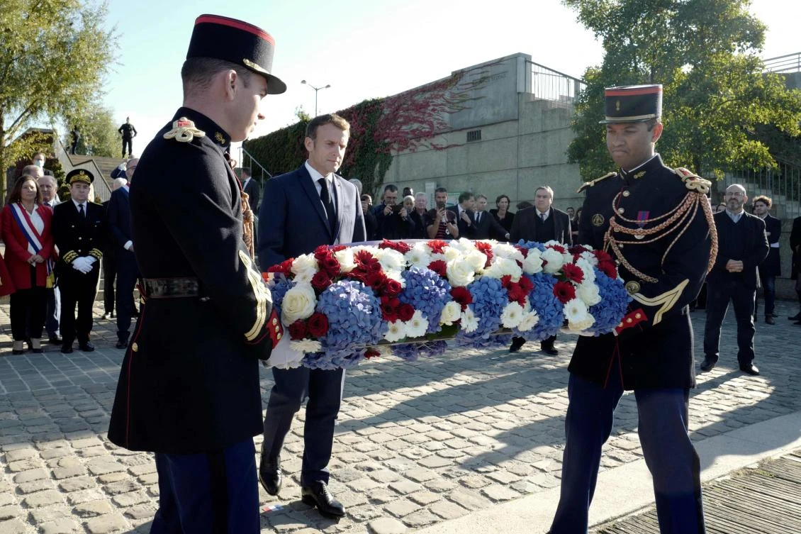 French President Emmanuel Macron lays a wreath near the Pont de Bezons, Oct. 16, 2021, in Colombes, near Paris. (AFP)